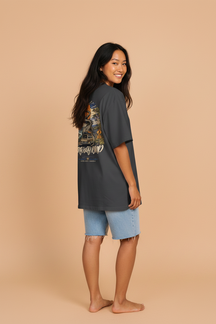 Long Way Round tee — coastal road and setting sun back print in orange, worn by a model
